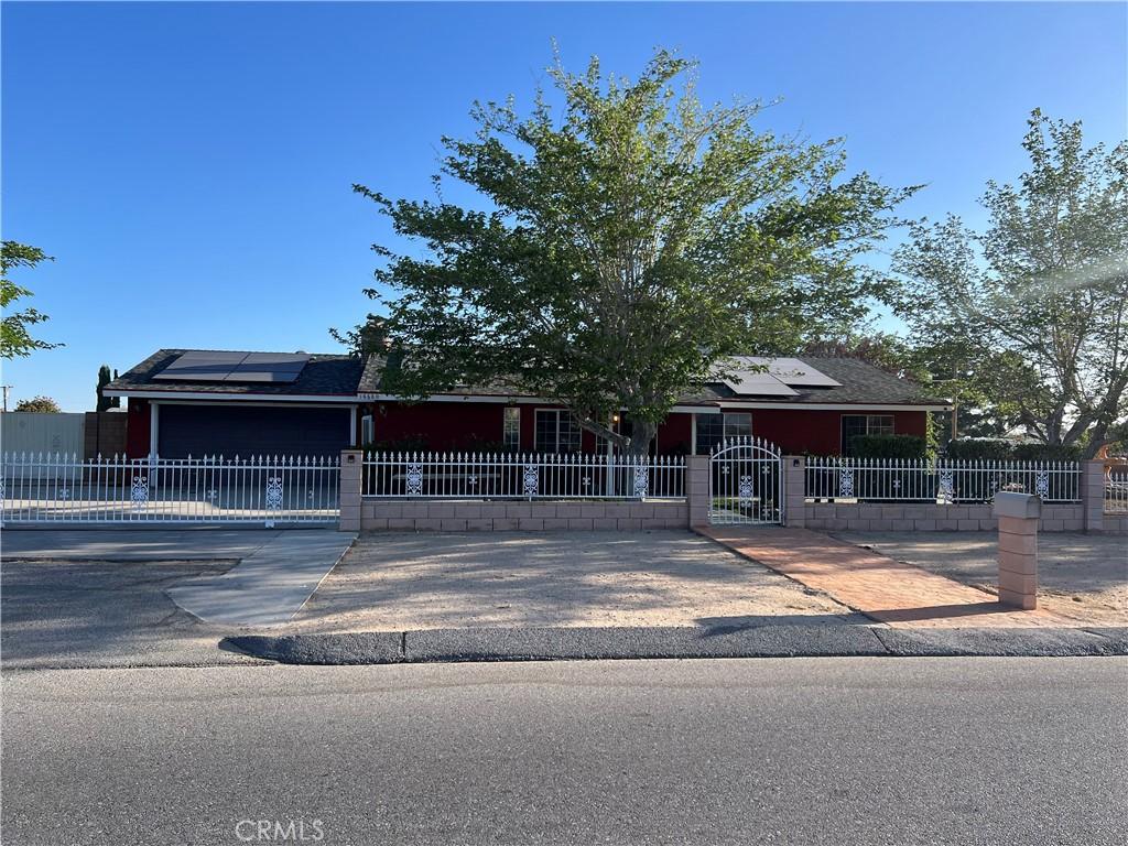14680 Luna Rd, Victorville, CA 92392 - view of front facade with a fenced front yard and roof mounted solar panels