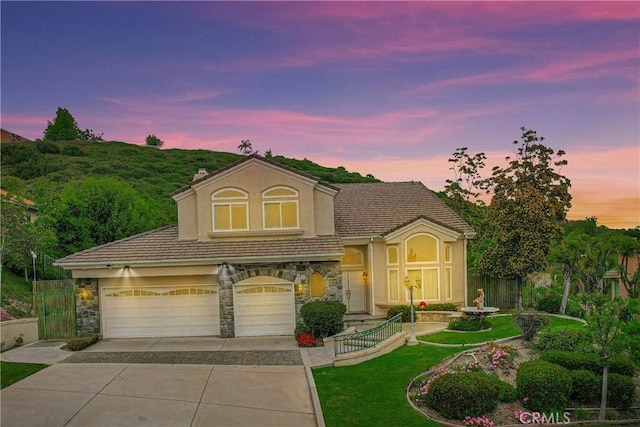 19861 Sunset Vista Rd, Walnut, CA 91789 - view of front of home with stone siding, driveway, an attached garage, a tile roof, and stucco siding
