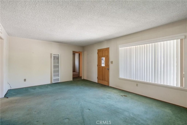 1359 W I St, Ontario, CA 91762 - unfurnished living room with a heating unit, carpet floors, and a textured ceiling