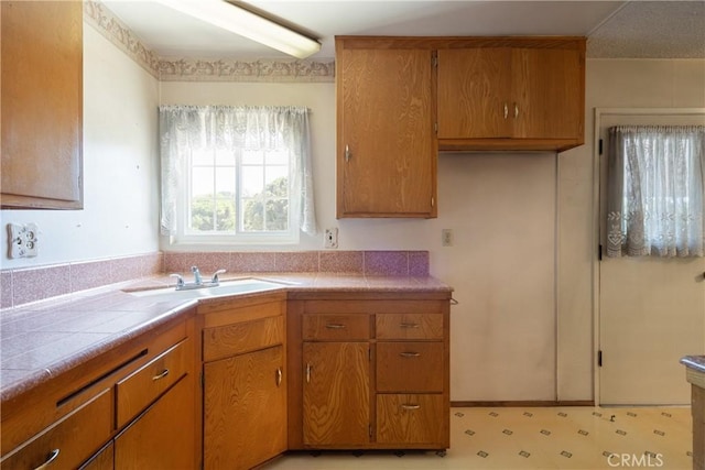 1359 W I St, Ontario, CA 91762 - kitchen with brown cabinets and tile counters