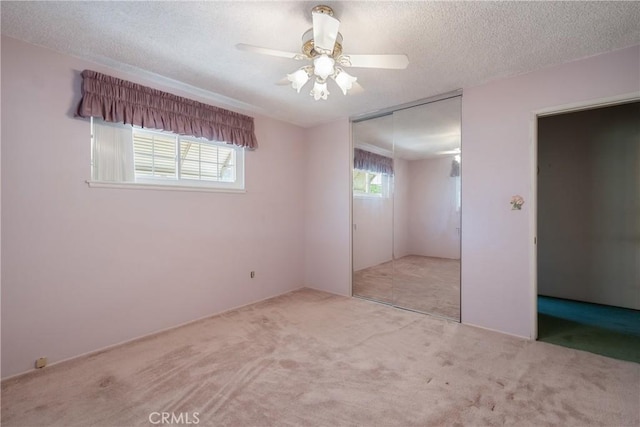 1359 W I St, Ontario, CA 91762 - unfurnished bedroom featuring carpet flooring, a closet, a textured ceiling, and a ceiling fan