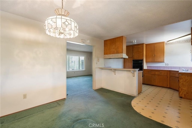 1359 W I St, Ontario, CA 91762 - kitchen featuring black oven, brown cabinetry, a peninsula, light countertops, and a breakfast bar