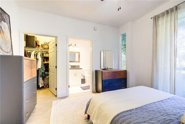 525 S Berendo St Unit 212, Los Angeles, CA 90020 - bedroom with light wood-type flooring, a walk in closet, a closet, and connected bathroom