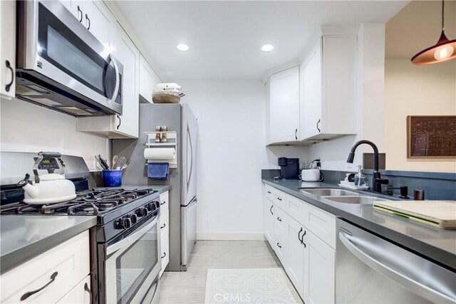 525 S Berendo St Unit 212, Los Angeles, CA 90020 - kitchen with stainless steel appliances, white cabinets, recessed lighting, dark countertops, and pendant lighting