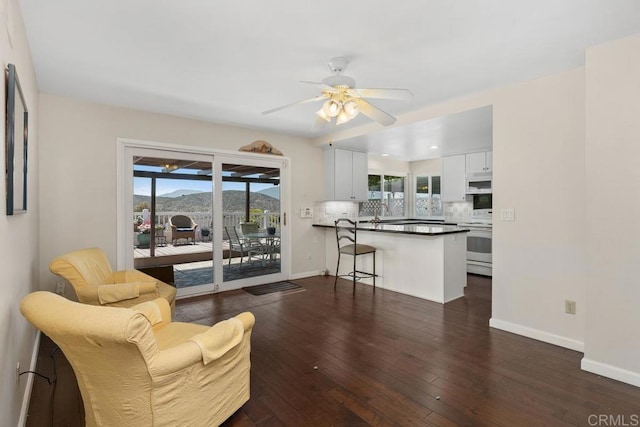 10879 Charing Cross Rd, Spring Valley, CA 91978 - living room with ceiling fan, plenty of natural light, and dark wood-style floors