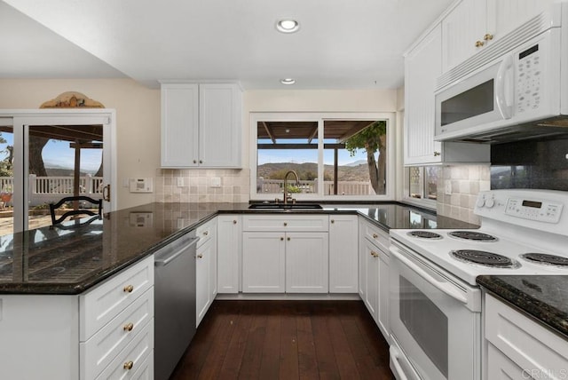10879 Charing Cross Rd, Spring Valley, CA 91978 - kitchen with white appliances, a peninsula, recessed lighting, white cabinets, and dark wood-style floors