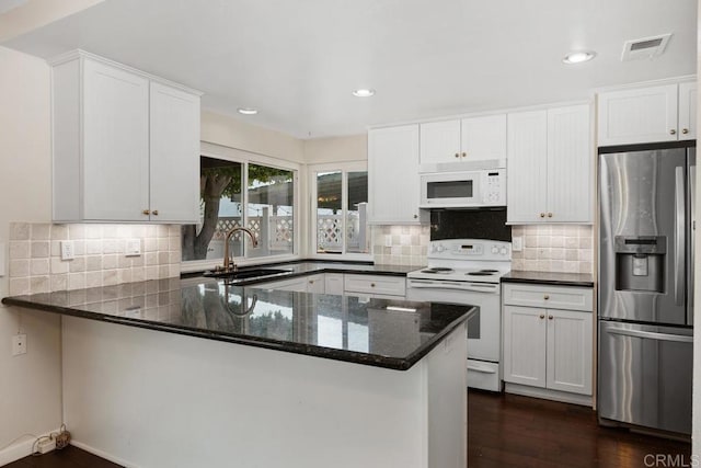 10879 Charing Cross Rd, Spring Valley, CA 91978 - kitchen featuring white appliances, dark stone countertops, dark wood finished floors, a peninsula, and white cabinetry