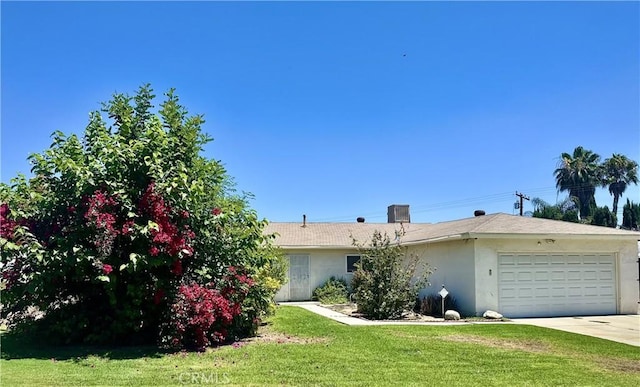 4957 Noble St, Riverside, CA 92503 - view of front of house featuring a garage, stucco siding, a front lawn, and concrete driveway
