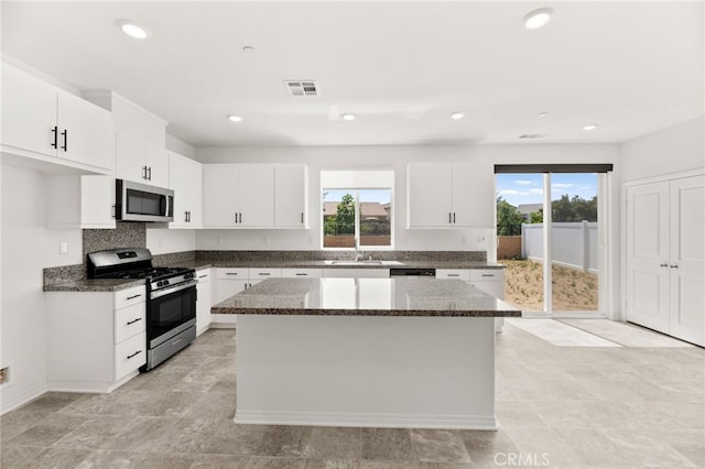 30181 Adrift Ln, Menifee, CA 92584 - kitchen featuring stainless steel appliances, healthy amount of natural light, a kitchen island, dark stone counters, and recessed lighting