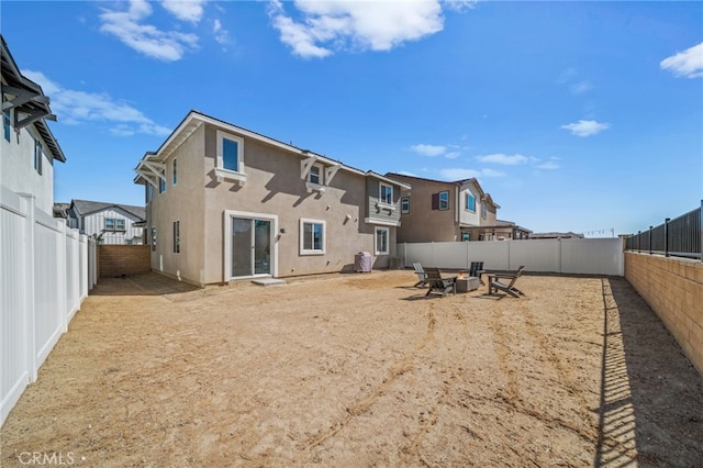 30181 Adrift Ln, Menifee, CA 92584 - rear view of property with stucco siding, a fenced backyard, and a fire pit