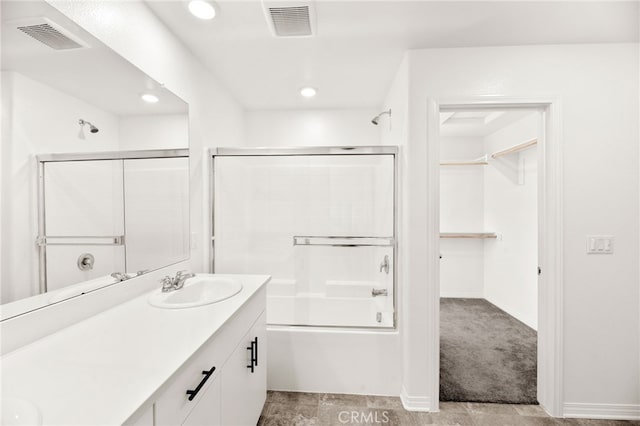 30181 Adrift Ln, Menifee, CA 92584 - bathroom with double vanity, shower / bath combination with glass door, recessed lighting, and a spacious closet