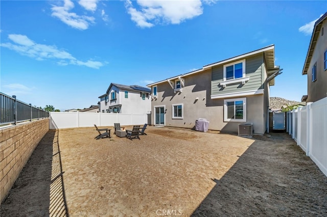 30181 Adrift Ln, Menifee, CA 92584 - back of house featuring an outdoor fire pit, stucco siding, and a fenced backyard