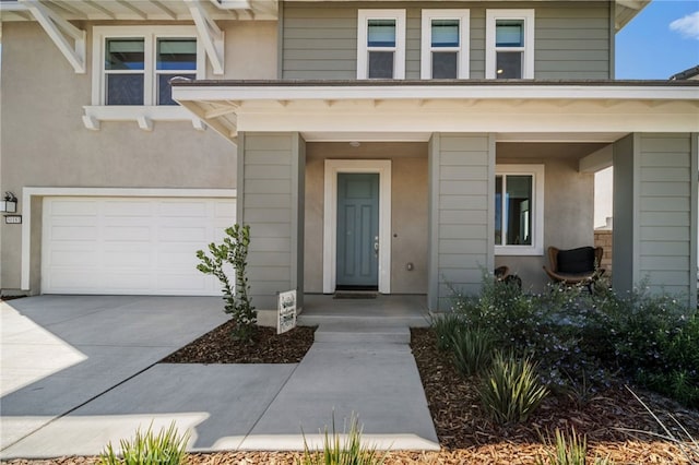 30181 Adrift Ln, Menifee, CA 92584 - view of exterior entry with a garage, concrete driveway, and stucco siding