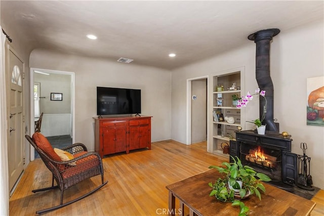 719 S Amstutz Ave, Anaheim, CA 92802 - living area featuring light wood-style floors, a wood stove, and recessed lighting