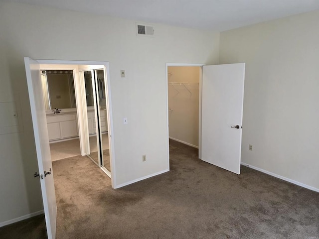 18680 Caminito Cantilena Unit 230, San Diego, CA 92128 - unfurnished bedroom featuring carpet, a walk in closet, a closet, and ensuite bath