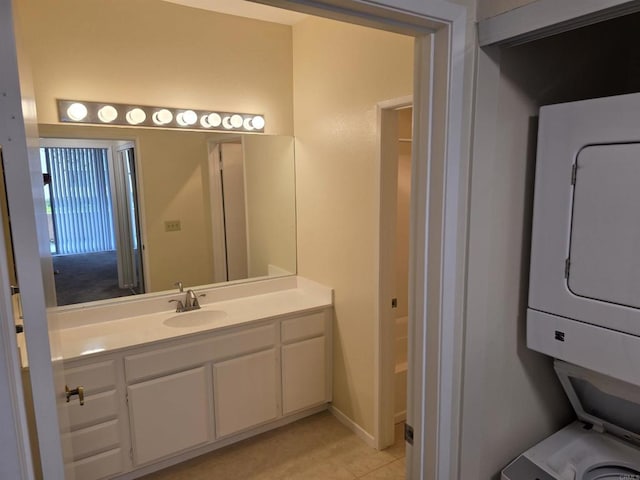 18680 Caminito Cantilena Unit 230, San Diego, CA 92128 - bathroom with estacked washer and dryer, vanity, and tile patterned flooring