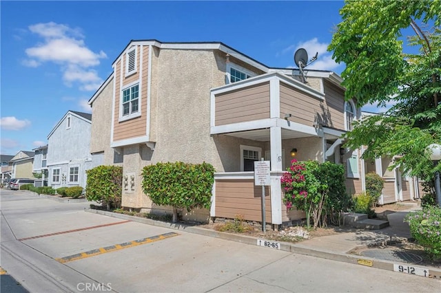 13303 Waco St Unit 62, Baldwin Park, CA 91706 - view of property exterior featuring stucco siding, a residential view, and a balcony