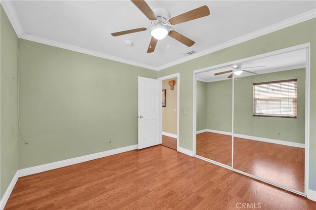 13303 Waco St Unit 62, Baldwin Park, CA 91706 - unfurnished bedroom with wood finished floors, crown molding, a ceiling fan, and a closet