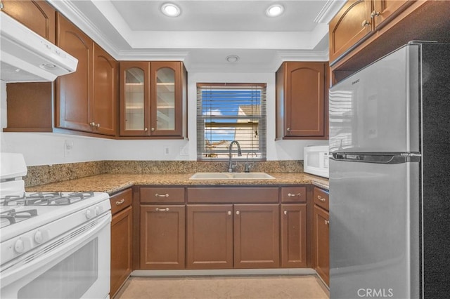 13303 Waco St Unit 62, Baldwin Park, CA 91706 - kitchen with white appliances, under cabinet range hood, a tray ceiling, light stone countertops, and recessed lighting