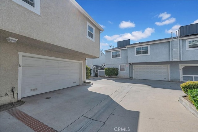 13303 Waco St Unit 62, Baldwin Park, CA 91706 - view of front of house with an attached garage, stucco siding, and concrete driveway