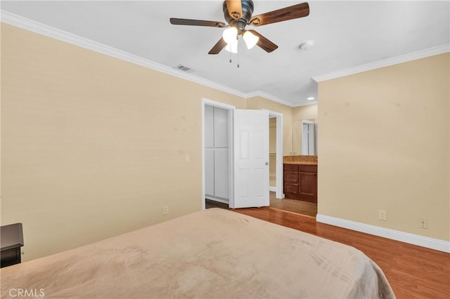 13303 Waco St Unit 62, Baldwin Park, CA 91706 - bedroom with wood finished floors, crown molding, connected bathroom, and ceiling fan