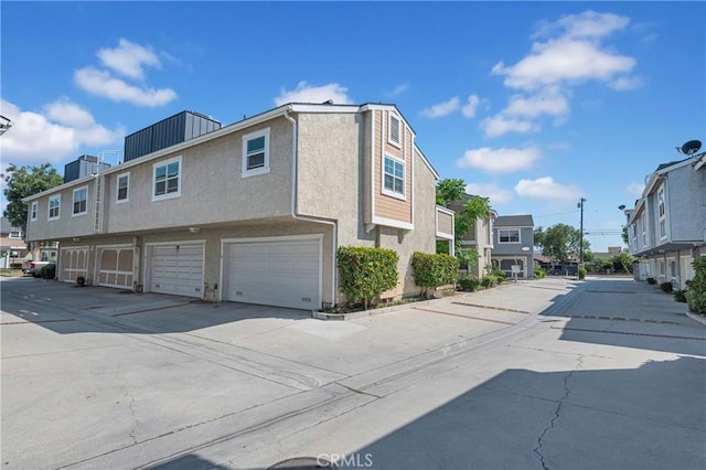 13303 Waco St Unit 62, Baldwin Park, CA 91706 - view of home's exterior with stucco siding, a residential view, and an attached garage