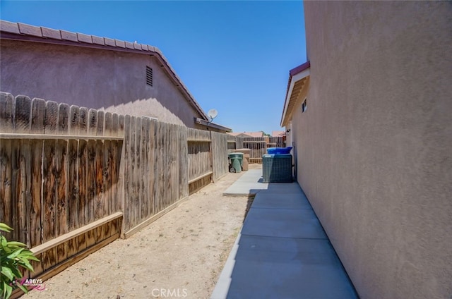 view of side of property with stucco siding and a patio