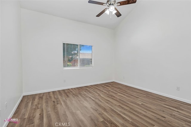 empty room featuring wood finished floors, ceiling fan, and vaulted ceiling