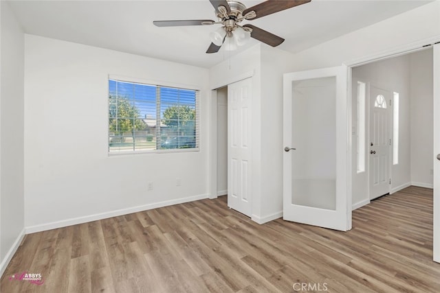 unfurnished bedroom featuring light wood-style flooring, a ceiling fan, and a closet