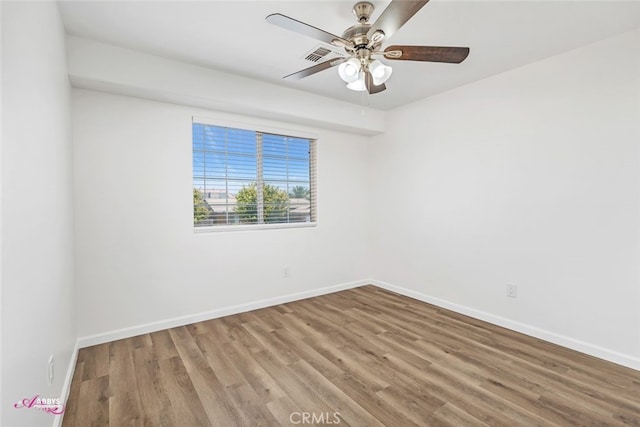 empty room featuring wood finished floors and a ceiling fan