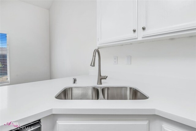 kitchen view of light countertops and white cabinets