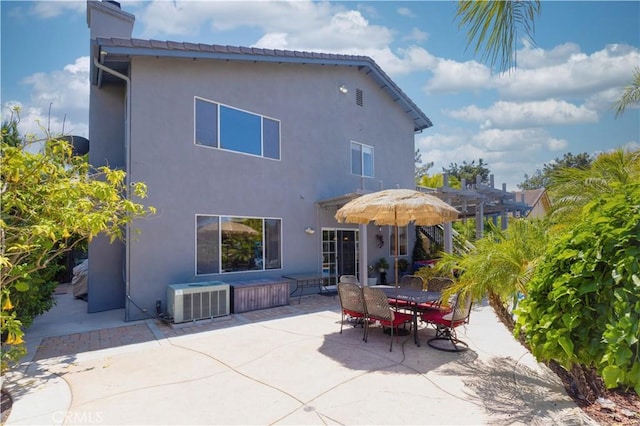 1555 Lupine Cir, Corona, CA 92881 - back of property with a patio, stucco siding, a chimney, and outdoor dining area