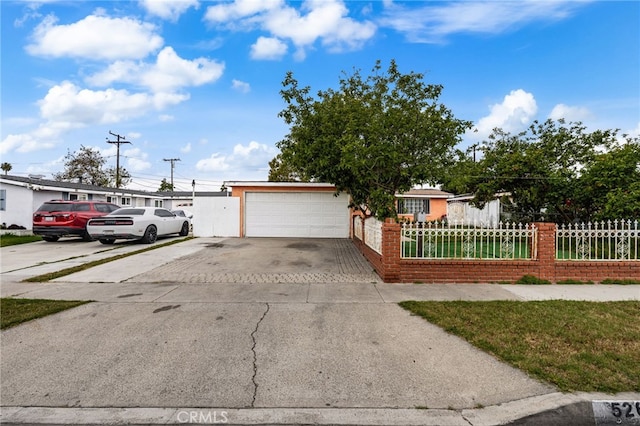526 Nottingham Ave, Santa Ana, CA 92703 - view of front of home with a fenced front yard, driveway, and a garage
