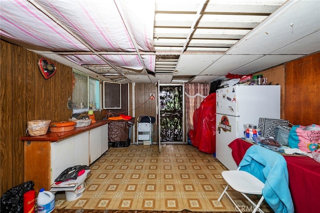 526 Nottingham Ave, Santa Ana, CA 92703 - finished basement with freestanding refrigerator, wooden walls, and light flooring
