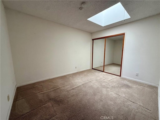 2402 Aviation Blvd Unit C, Redondo Beach, CA 90278 - unfurnished bedroom with a skylight, carpet, a textured ceiling, and a closet