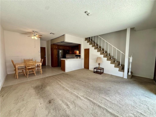 2402 Aviation Blvd Unit C, Redondo Beach, CA 90278 - unfurnished living room with light colored carpet, stairway, a textured ceiling, a ceiling fan, and light tile patterned floors
