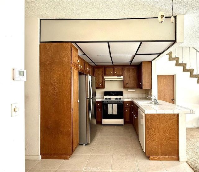 2402 Aviation Blvd Unit C, Redondo Beach, CA 90278 - kitchen with white appliances, under cabinet range hood, tile countertops, and light tile patterned flooring