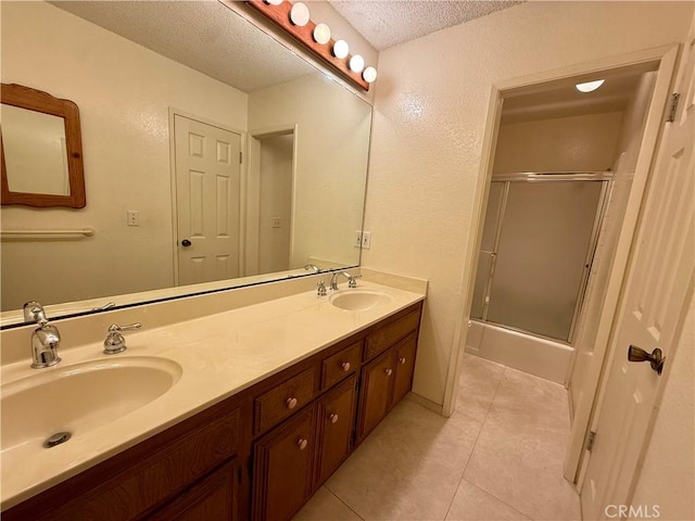 2402 Aviation Blvd Unit C, Redondo Beach, CA 90278 - bathroom with a textured ceiling, double vanity, tile patterned flooring, enclosed tub / shower combo, and a textured wall