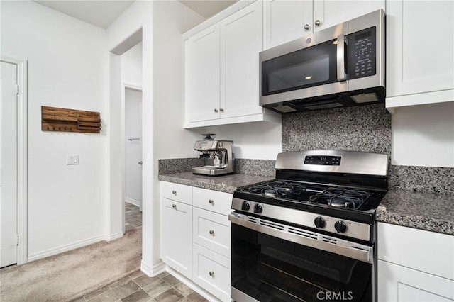 16502 Casa Grande Ave Unit 102, Fontana, CA 92336 - kitchen featuring stainless steel appliances, white cabinetry, backsplash, and light carpet