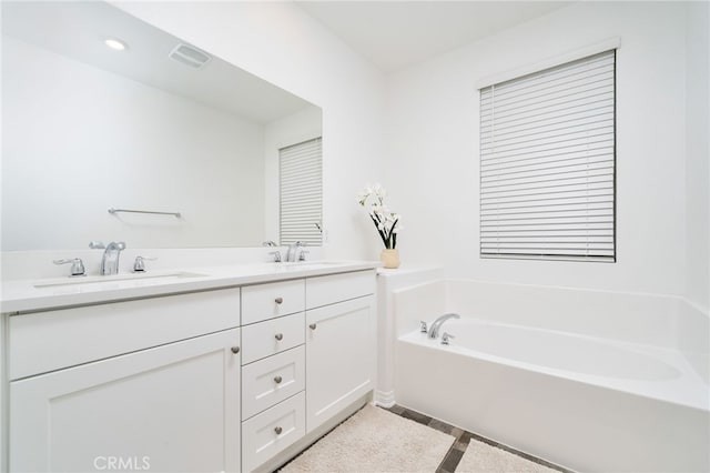 16502 Casa Grande Ave Unit 102, Fontana, CA 92336 - bathroom featuring double vanity, a garden tub, tile patterned floors, and recessed lighting