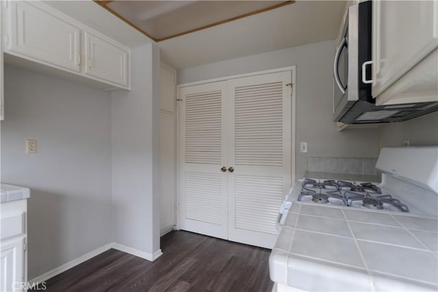 6186 Hefley St Unit 13, Westminster, CA 92683 - kitchen featuring tile countertops, white gas range oven, dark wood-type flooring, stainless steel microwave, and white cabinetry