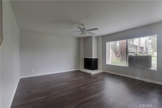 6186 Hefley St Unit 13, Westminster, CA 92683 - unfurnished living room featuring a brick fireplace, dark wood-style flooring, and ceiling fan