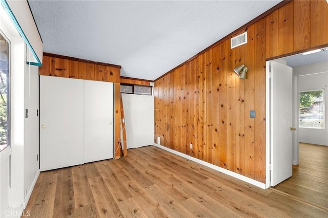 1204 San Jacinto, Redlands, CA 92373 - unfurnished bedroom featuring light wood-type flooring and wood walls