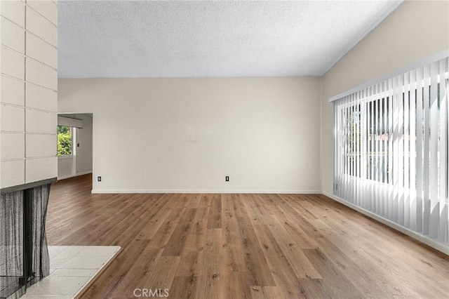 1204 San Jacinto, Redlands, CA 92373 - empty room with light wood-style flooring, a textured ceiling, and lofted ceiling