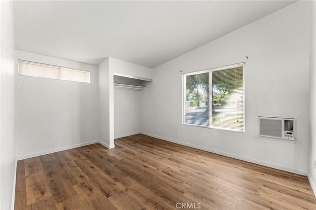 1204 San Jacinto, Redlands, CA 92373 - unfurnished bedroom featuring wood finished floors, a closet, lofted ceiling, and a wall unit AC