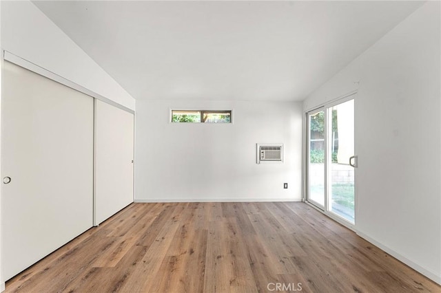 1204 San Jacinto, Redlands, CA 92373 - unfurnished bedroom with access to outside, light wood-style flooring, an AC wall unit, lofted ceiling, and a closet