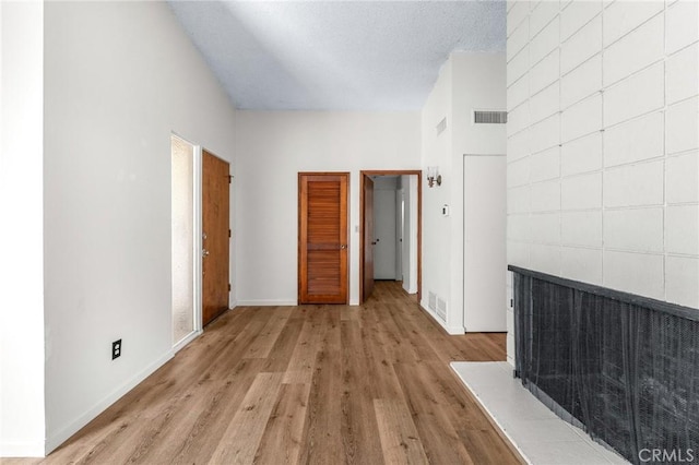 1204 San Jacinto, Redlands, CA 92373 - unfurnished living room featuring light wood-type flooring and a multi sided fireplace