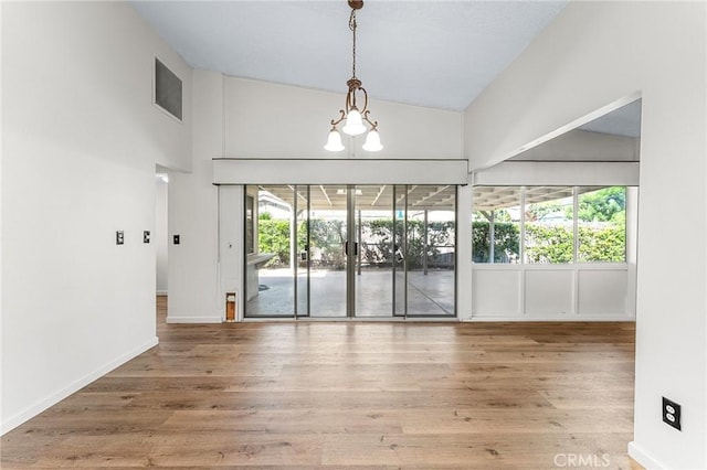 1204 San Jacinto, Redlands, CA 92373 - empty room with a chandelier, wood finished floors, and high vaulted ceiling