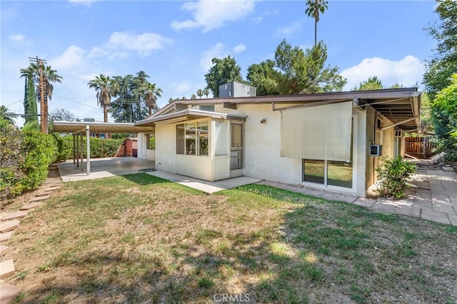 1204 San Jacinto, Redlands, CA 92373 - rear view of house with an attached carport, stucco siding, and a patio area