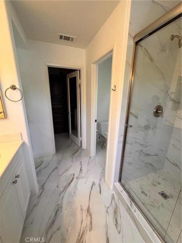 44 Arcata, Irvine, CA 92602 - bathroom featuring a marble finish shower, vanity, and marble finish flooring